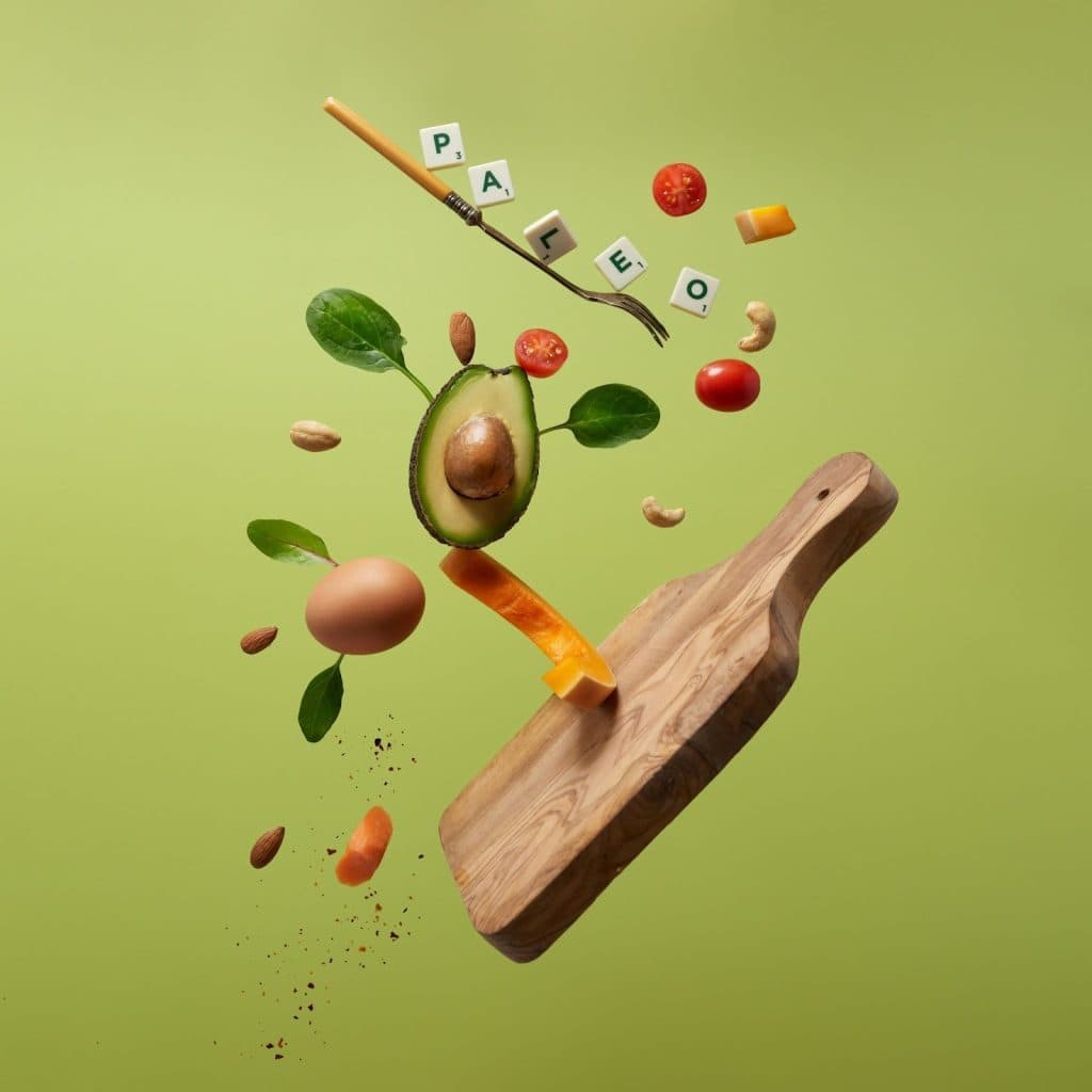 an avocado and herbs and tomatoes tossed for contrast on a cutting board
